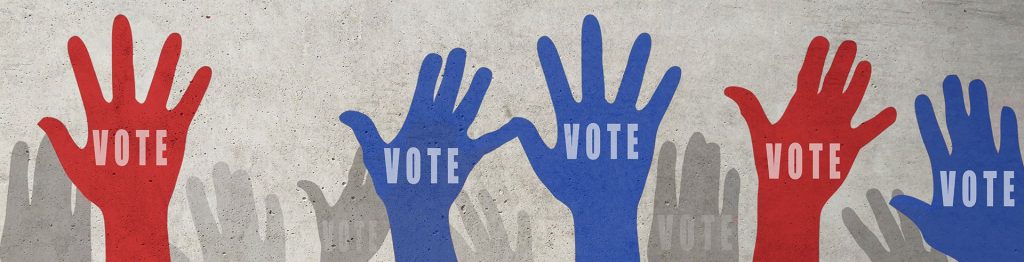 Illustration of raised hands marked Vote in red and blue.